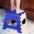 Durable folding step stool with a vibrant multicolor design and a handle for easy portability.